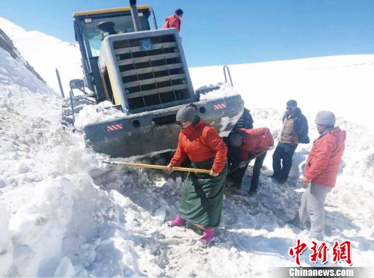 圖為普布卓瑪(左一)與養(yǎng)護工人一起抗擊雪災(zāi)，搶險保通?！“⒗锏貐^(qū)公路養(yǎng)護段供圖 攝